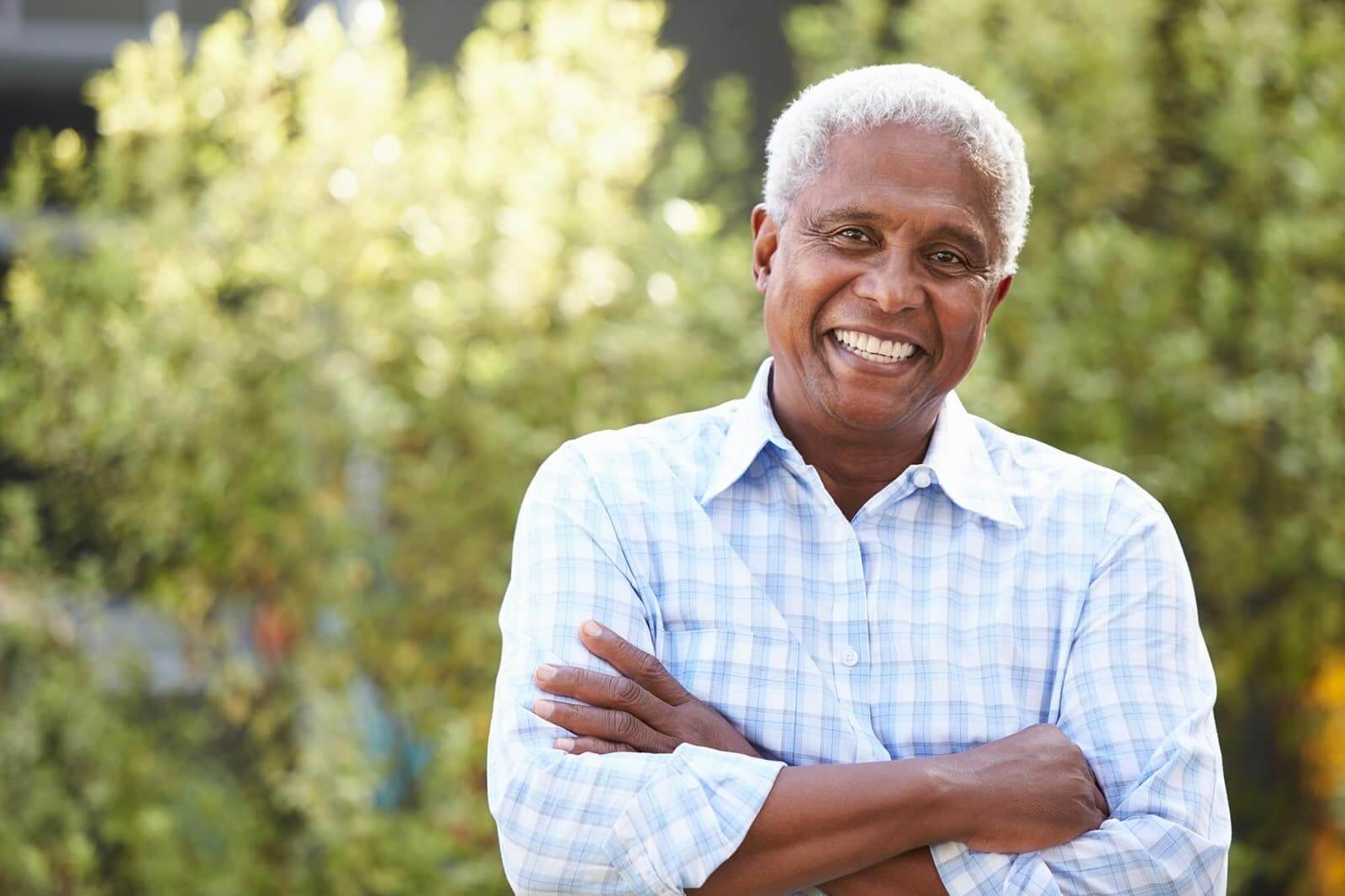 Senior man smiling outside