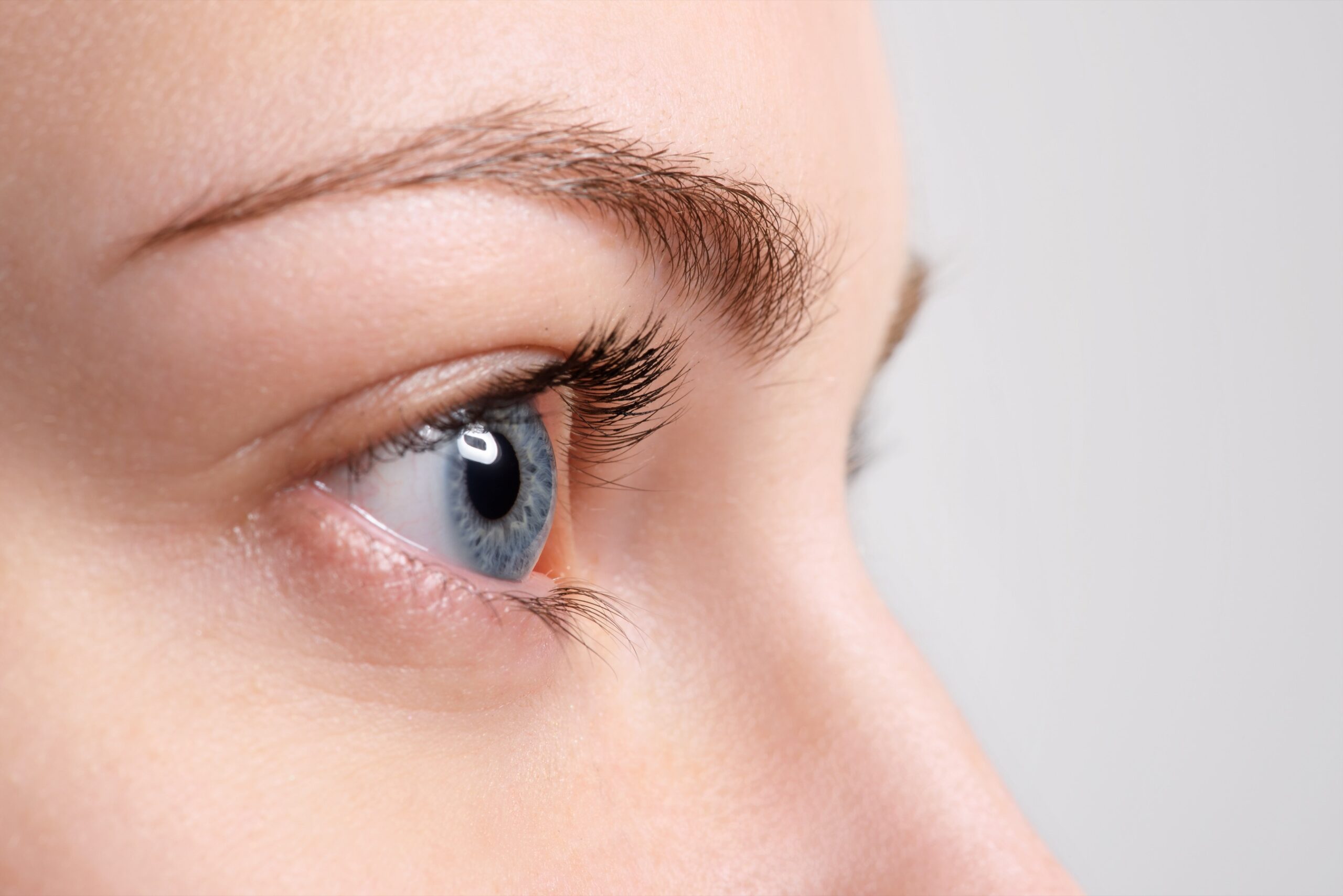 Close up blue eye with natural makeup looking at the side