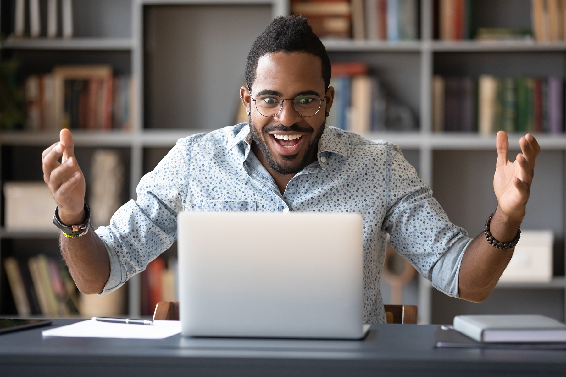 excited young man with laptop computer