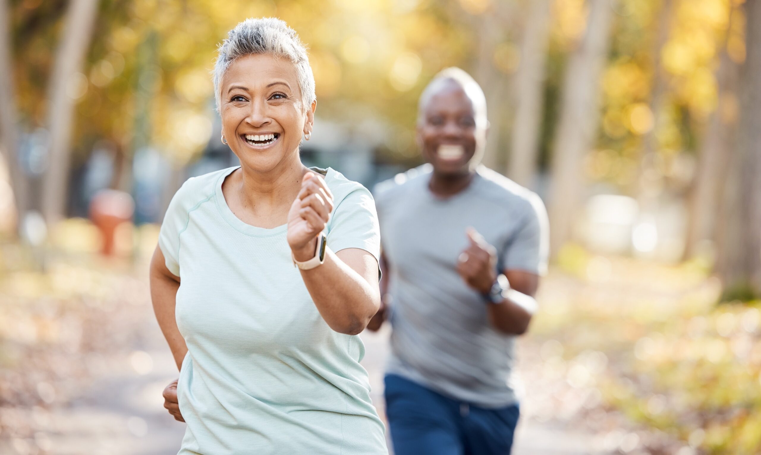 Active older couple walking in a park