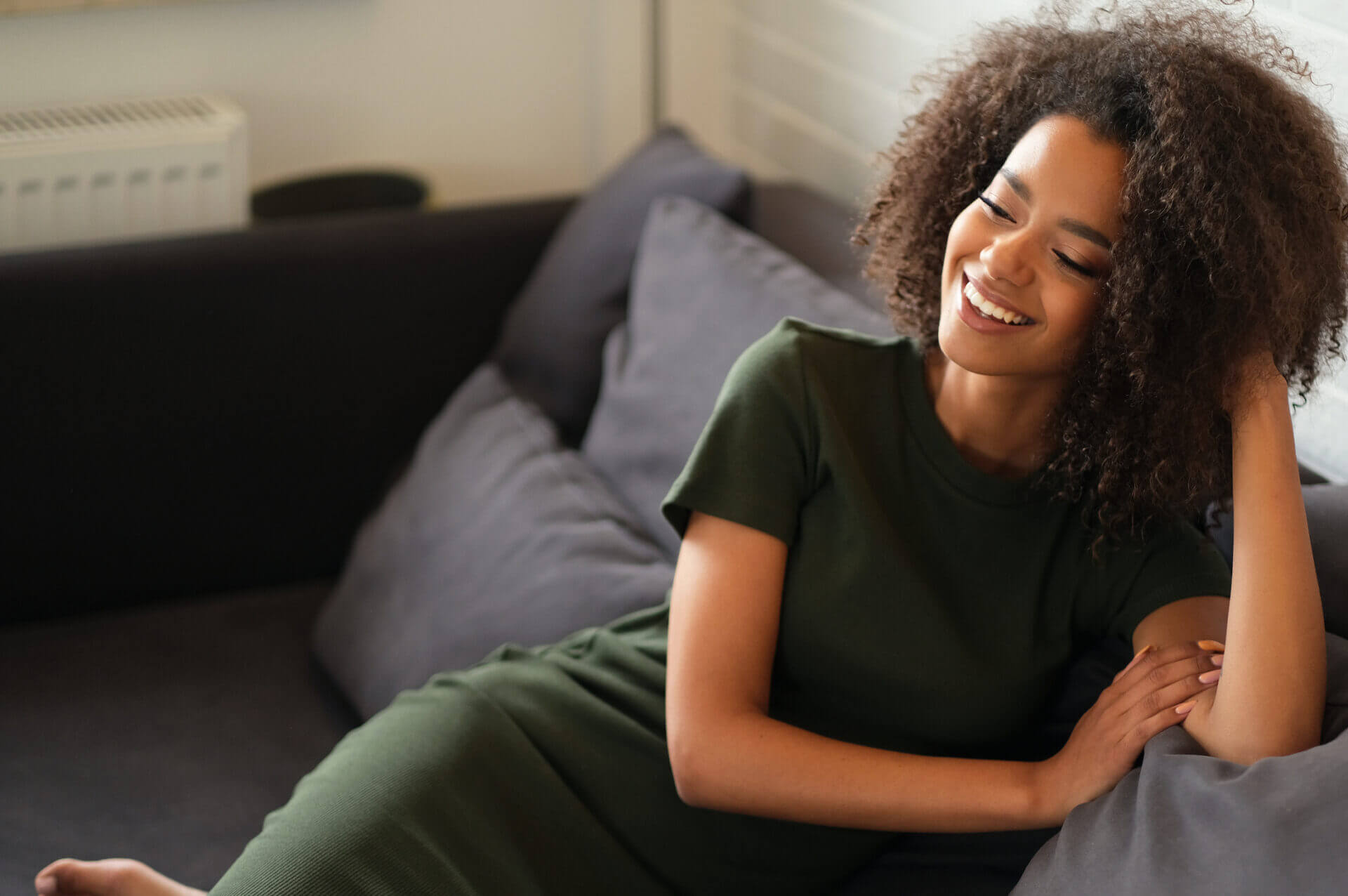 Happy woman on a couch at home