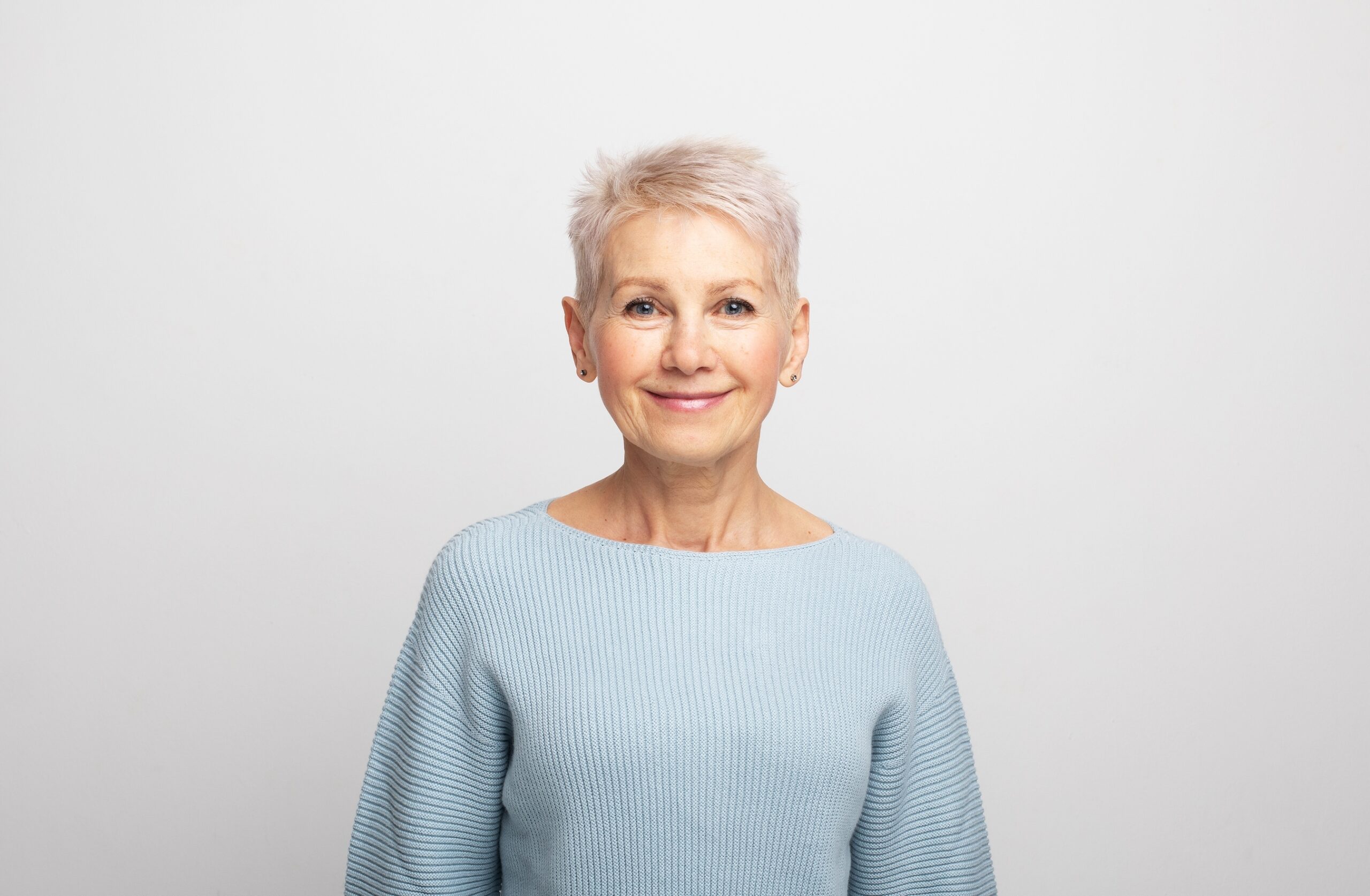 Woman in a blue sweater on a gray background