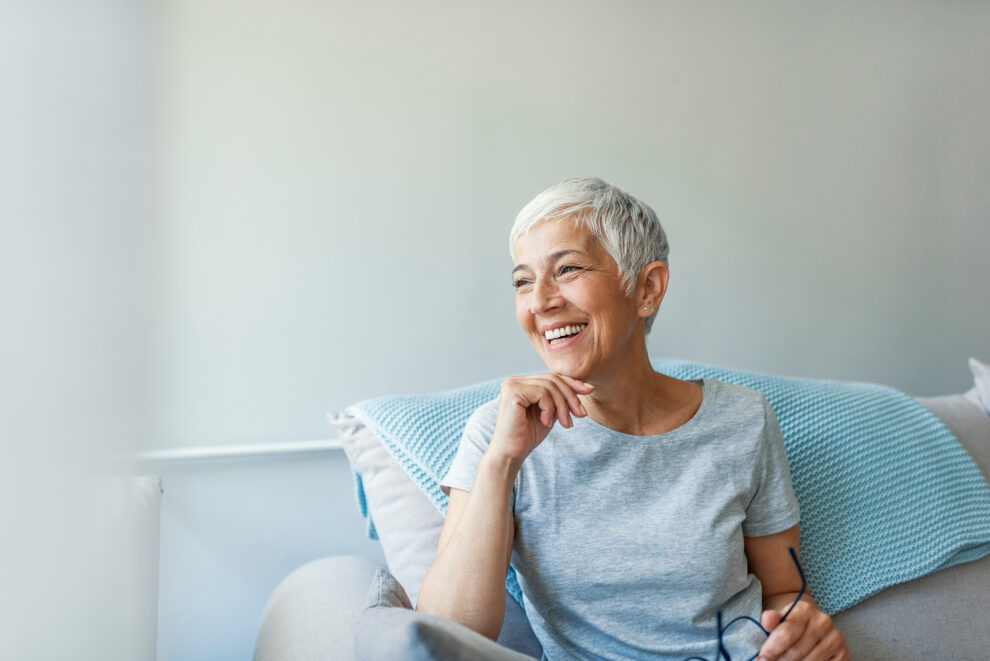 Happy woman relaxing on her couch at home