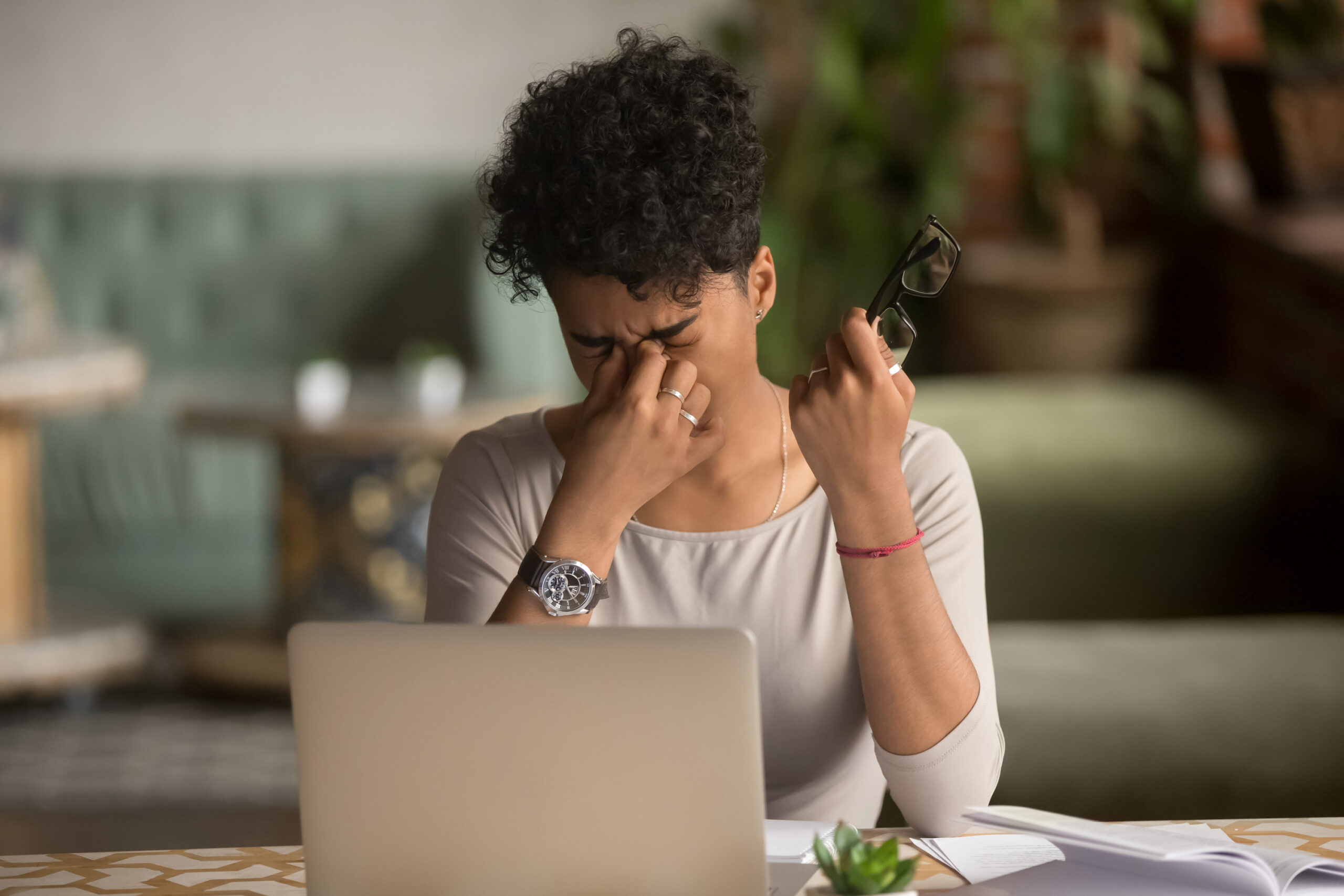 Woman holding glasses feel eye strain fatigue after computer work,